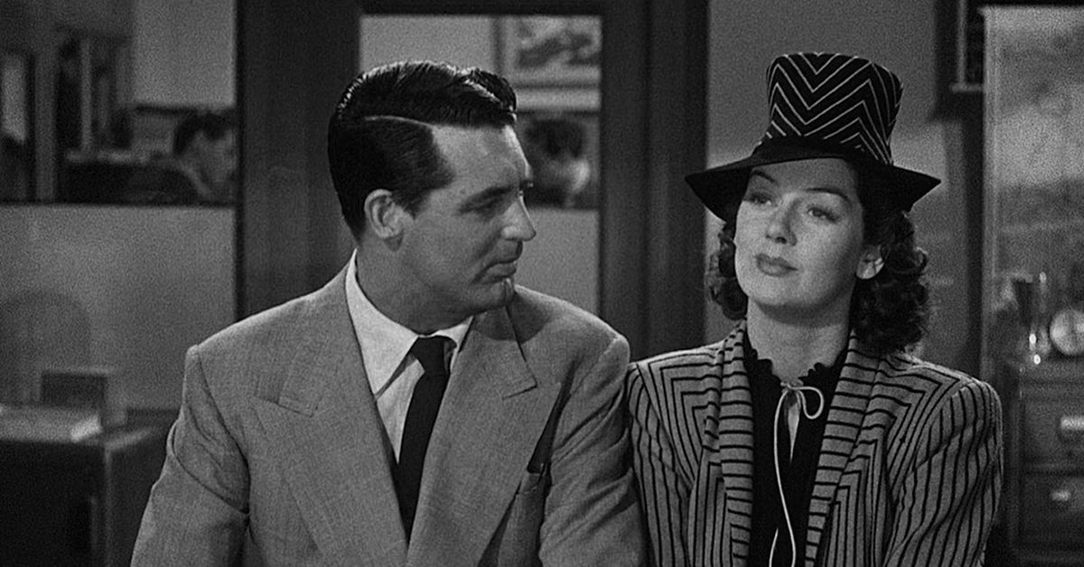 A screenshot from the movie His Girl Friday, with Cary Grant (left) looking at Rosalind Russell (right).